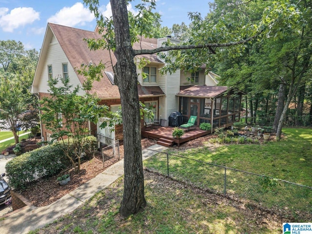1505 Cypress Ln, Hoover, AL 35244 - view of front of home with a sunroom, a wooden deck, roof with shingles, a chimney, and brick siding