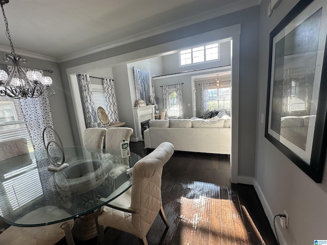 1013 Edgewater Ln, Chelsea, AL 35043 - dining area featuring ornamental molding, a chandelier, baseboards, and dark wood-type flooring