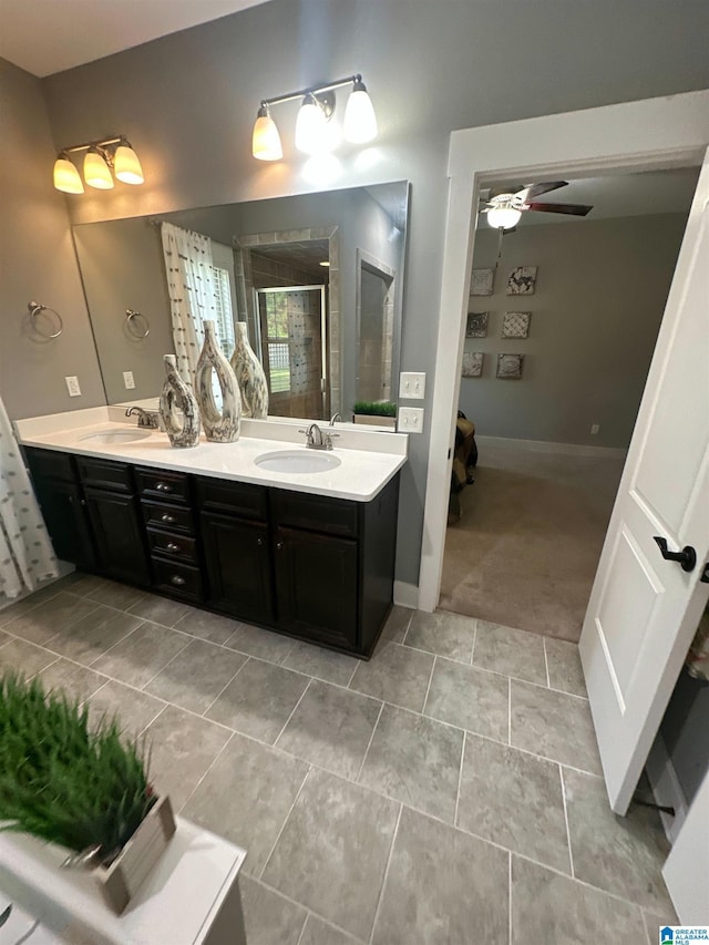 1013 Edgewater Ln, Chelsea, AL 35043 - bathroom with double vanity, a stall shower, ceiling fan, baseboards, and connected bathroom