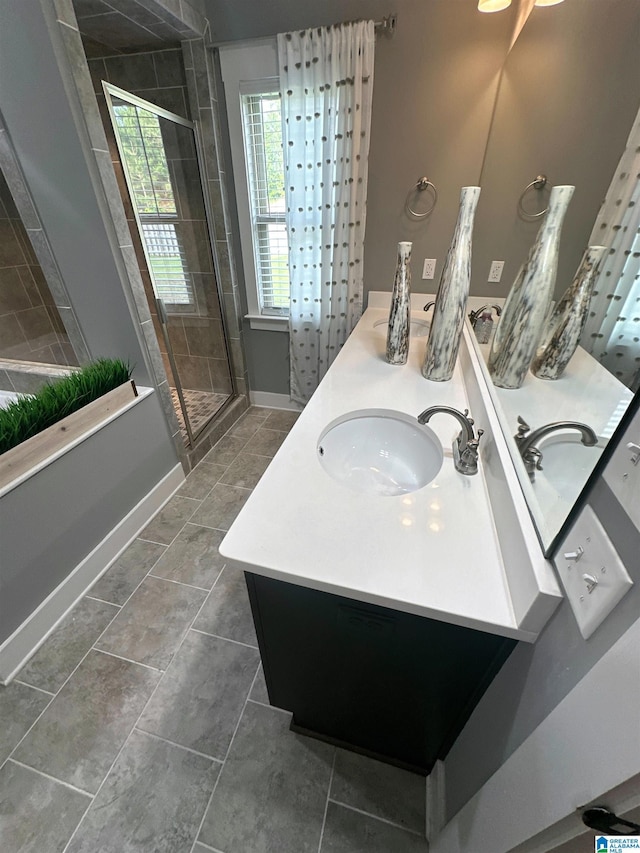 1013 Edgewater Ln, Chelsea, AL 35043 - bathroom with double vanity, a stall shower, baseboards, and tile patterned flooring
