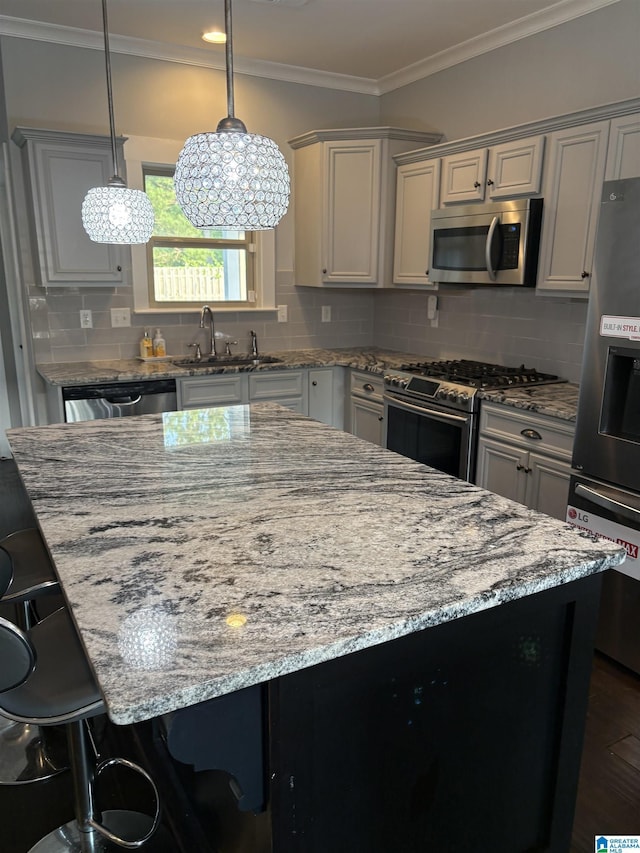 1013 Edgewater Ln, Chelsea, AL 35043 - kitchen with stainless steel appliances, a sink, light stone countertops, a kitchen bar, and a center island