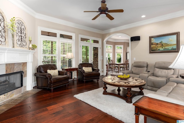 4025 Grove Park Cir, Birmingham, AL 35242 - living room featuring arched walkways, a ceiling fan, dark wood-type flooring, a tile fireplace, and ornamental molding