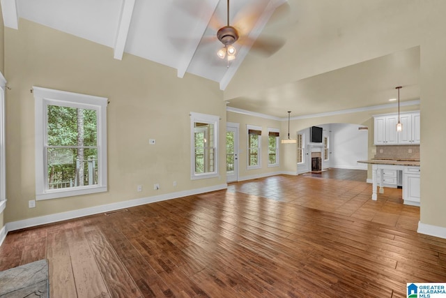 101 N Lake Dr, Hoover, AL 35242 - unfurnished living room featuring arched walkways, healthy amount of natural light, a ceiling fan, and wood finished floors