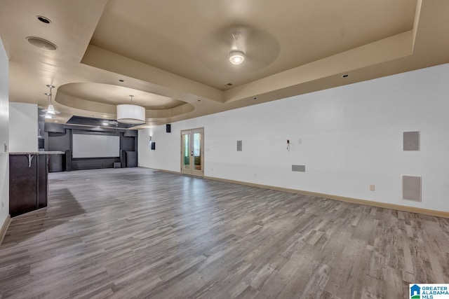 101 N Lake Dr, Hoover, AL 35242 - unfurnished living room with a raised ceiling, wood finished floors, and a ceiling fan