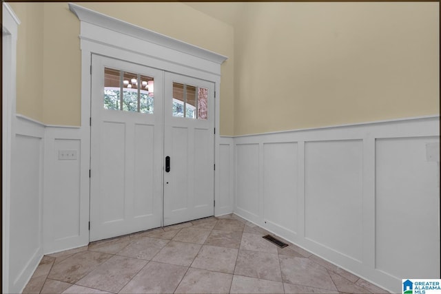 101 N Lake Dr, Hoover, AL 35242 - foyer with a decorative wall, a wainscoted wall, and light tile patterned floors