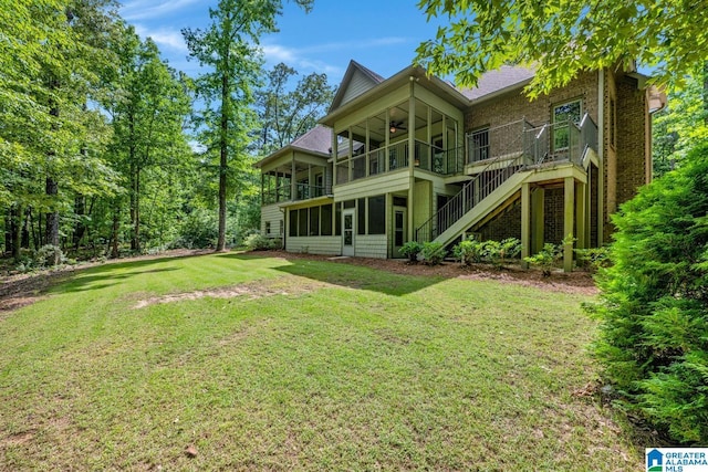 101 N Lake Dr, Hoover, AL 35242 - back of property with a sunroom, a ceiling fan, stairs, a lawn, and brick siding