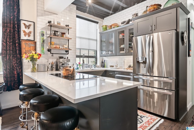 2201 1st Ave N Unit 300-C, Birmingham, AL 35203 - kitchen featuring stainless steel refrigerator with ice dispenser, a peninsula, backsplash, open shelves, and light countertops