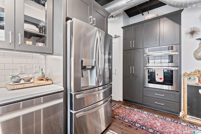 2201 1st Ave N Unit 300-C, Birmingham, AL 35203 - kitchen featuring appliances with stainless steel finishes, dark wood-style floors, decorative backsplash, and gray cabinets