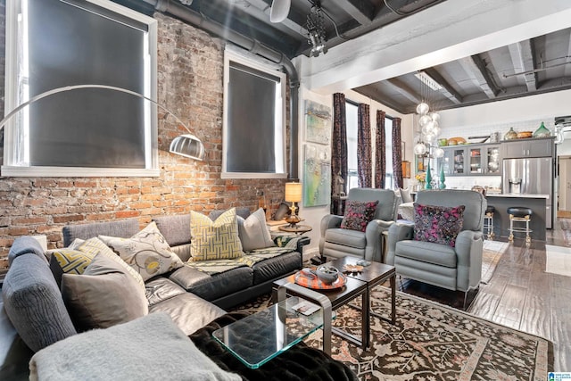 2201 1st Ave N Unit 300-C, Birmingham, AL 35203 - living area featuring beamed ceiling, brick wall, and wood finished floors