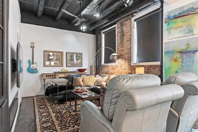2201 1st Ave N Unit 300-C, Birmingham, AL 35203 - living room featuring wood finished floors, baseboards, and brick wall
