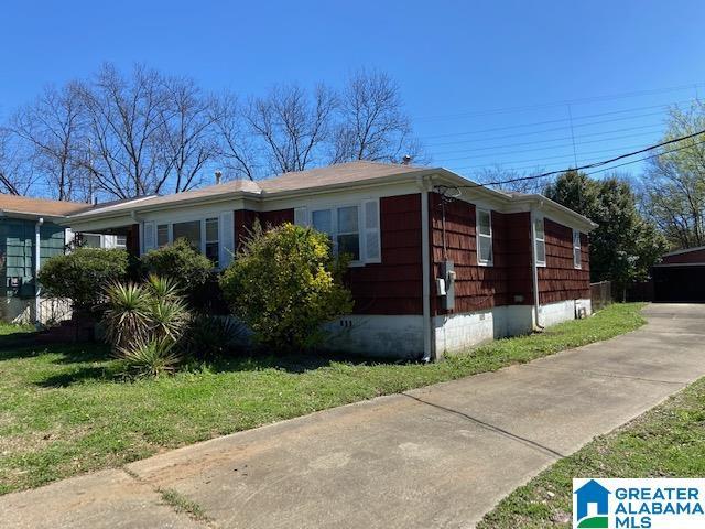 2005 49th St W, Birmingham, AL 35208 - view of side of home with a yard