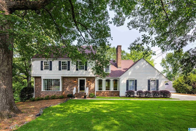 3701 Rockhill Rd, Mountain Brook, AL 35223 - view of front of home featuring a chimney, a front lawn, and brick siding
