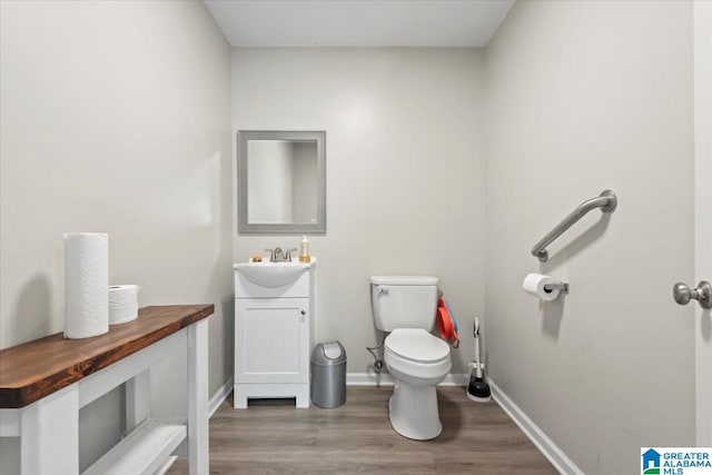 117 Trafford Rd, Warrior, AL 35180 - bathroom with toilet, vanity, wood finished floors, and baseboards