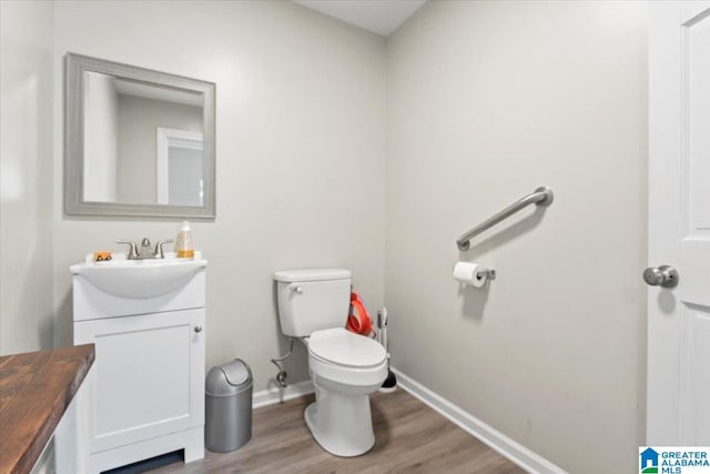 117 Trafford Rd, Warrior, AL 35180 - bathroom with vanity, wood finished floors, toilet, and baseboards