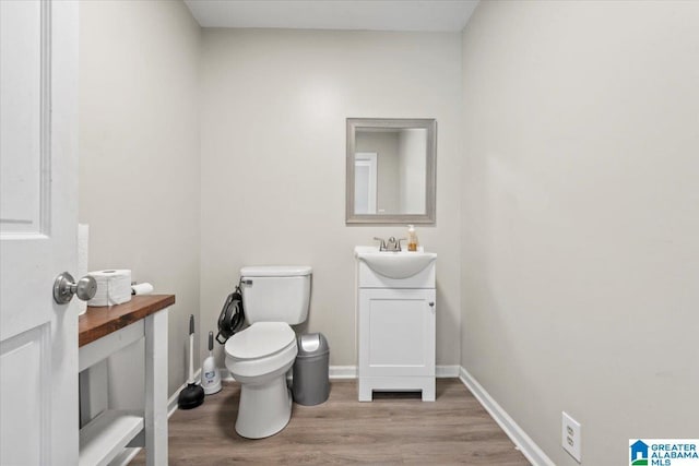 117 Trafford Rd, Warrior, AL 35180 - half bath featuring vanity, wood finished floors, toilet, and baseboards