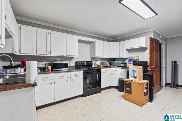 117 Trafford Rd, Warrior, AL 35180 - kitchen featuring electric range, stainless steel microwave, dark countertops, white cabinetry, and ornamental molding