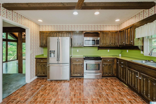 3321 Shetland Trce, Birmingham, AL 35242 - kitchen featuring stainless steel appliances, wallpapered walls, a sink, brick patterned floors, and dark brown cabinetry