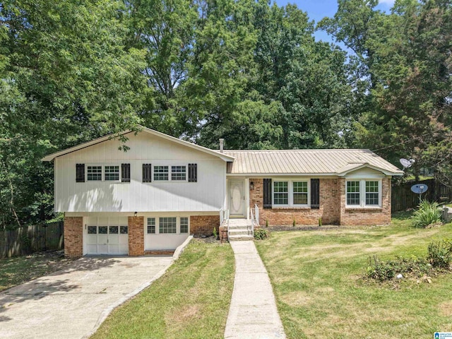 1460 4th Pl NW, Center Point, AL 35215 - tri-level home with a garage, brick siding, concrete driveway, and metal roof