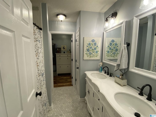 13634 Lisa Dr, Lake View, AL 35111 - bathroom with double vanity, a textured ceiling, tile patterned flooring, curtained shower, and baseboards