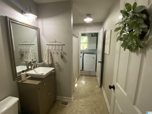 13634 Lisa Dr, Lake View, AL 35111 - bathroom featuring independent washer and dryer, vanity, toilet, baseboards, and a shower with shower curtain