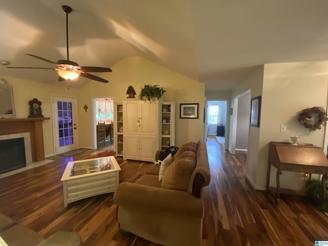 13634 Lisa Dr, Lake View, AL 35111 - living room featuring wood finished floors, vaulted ceiling, a fireplace with flush hearth, ceiling fan, and baseboards