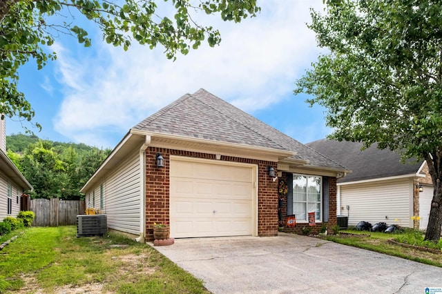 347 Forest Lakes Dr, Sterrett, AL 35147 - view of front of home featuring a garage, brick siding, concrete driveway, central AC, and roof with shingles