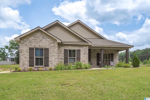 13129 Fondren Rd, Northport, AL 35475 - view of front facade with brick siding, a front lawn, and covered porch