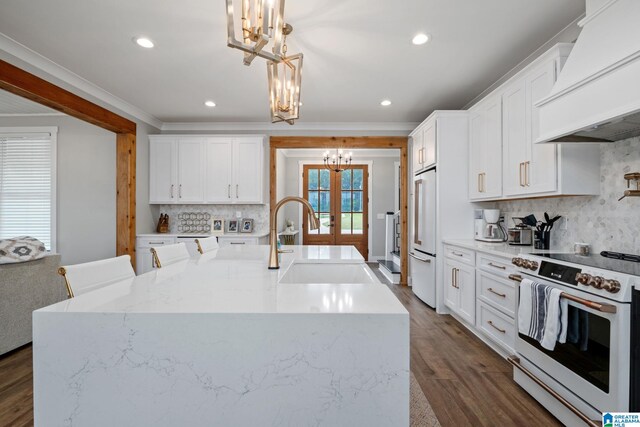 1165 Cedar Creek Dr, Sylacauga, AL 35151 - kitchen with white appliances, premium range hood, a sink, a chandelier, and backsplash
