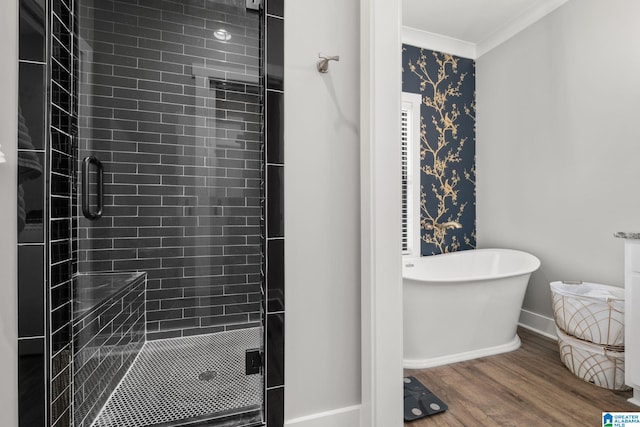 1165 Cedar Creek Dr, Sylacauga, AL 35151 - full bathroom featuring a stall shower, crown molding, wood finished floors, a soaking tub, and baseboards