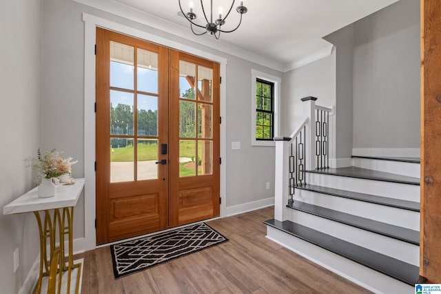 1165 Cedar Creek Dr, Sylacauga, AL 35151 - foyer featuring french doors, wood finished floors, a chandelier, and crown molding