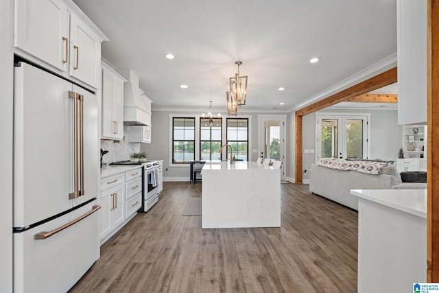 1165 Cedar Creek Dr, Sylacauga, AL 35151 - kitchen featuring white appliances, open floor plan, custom range hood, healthy amount of natural light, and ornamental molding