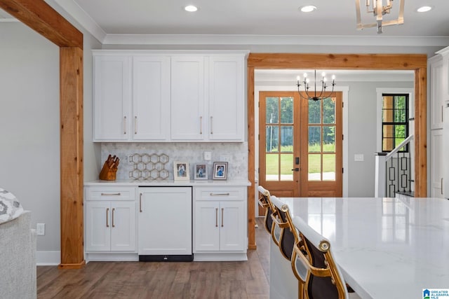 1165 Cedar Creek Dr, Sylacauga, AL 35151 - kitchen featuring a chandelier, french doors, light wood finished floors, white cabinetry, and recessed lighting