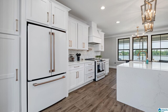 1165 Cedar Creek Dr, Sylacauga, AL 35151 - kitchen featuring high end white refrigerator, range with electric stovetop, custom range hood, a chandelier, and white cabinets