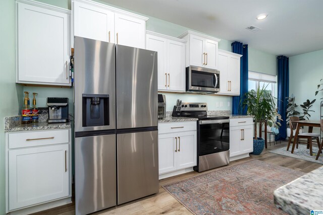 154 Halifax Ln, Chelsea, AL 35043 - kitchen featuring stainless steel appliances, light wood-style flooring, white cabinets, light stone countertops, and recessed lighting