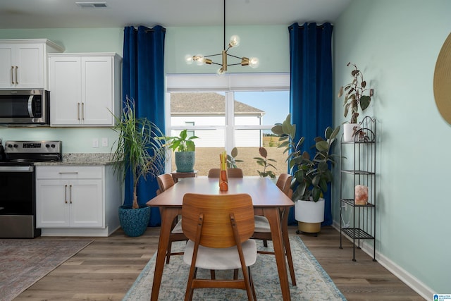 154 Halifax Ln, Chelsea, AL 35043 - dining room with a chandelier and light wood-type flooring