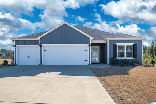 154 Halifax Ln, Chelsea, AL 35043 - view of front facade featuring board and batten siding, a garage, and concrete driveway