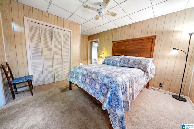 580 3rd St SW, Ashland, AL 36251 - carpeted bedroom with wood walls, a closet, a ceiling fan, and a drop ceiling