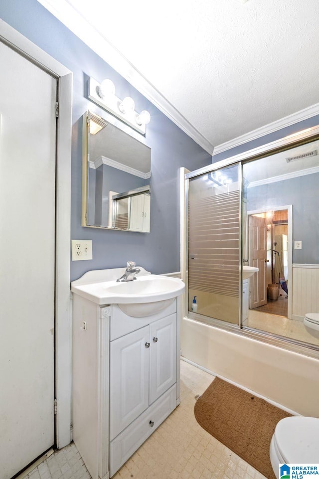 580 3rd St SW, Ashland, AL 36251 - bathroom with toilet, vanity, bath / shower combo with glass door, tile patterned floors, and crown molding