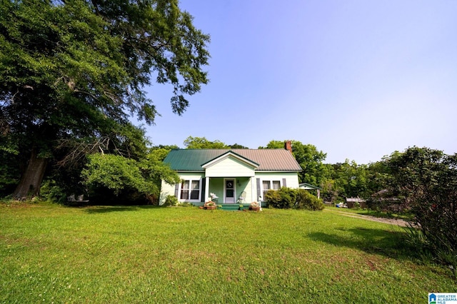 580 3rd St SW, Ashland, AL 36251 - ranch-style home featuring a chimney, a front yard, metal roof, and a porch
