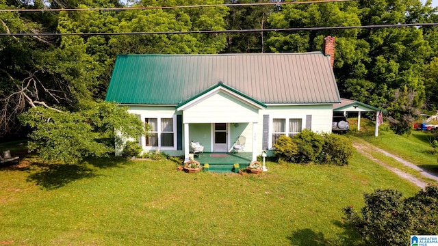 580 3rd St SW, Ashland, AL 36251 - view of front of property featuring a front lawn, dirt driveway, a chimney, and an attached carport