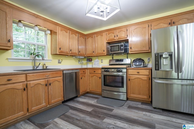 13339 Sylvia Dr, Lake View, AL 35111 - kitchen featuring stainless steel appliances, a sink, dark wood-style flooring, brown cabinetry, and light countertops