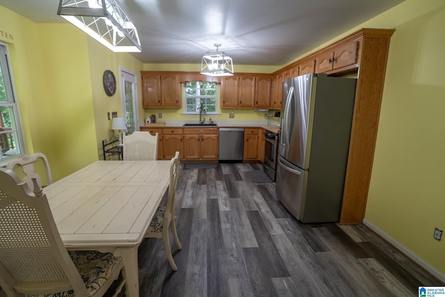 13339 Sylvia Dr, Lake View, AL 35111 - kitchen with appliances with stainless steel finishes, dark wood-style floors, a sink, decorative light fixtures, and light countertops