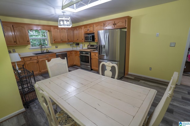 13339 Sylvia Dr, Lake View, AL 35111 - kitchen with stainless steel appliances, a sink, a skylight, and dark wood-style floors
