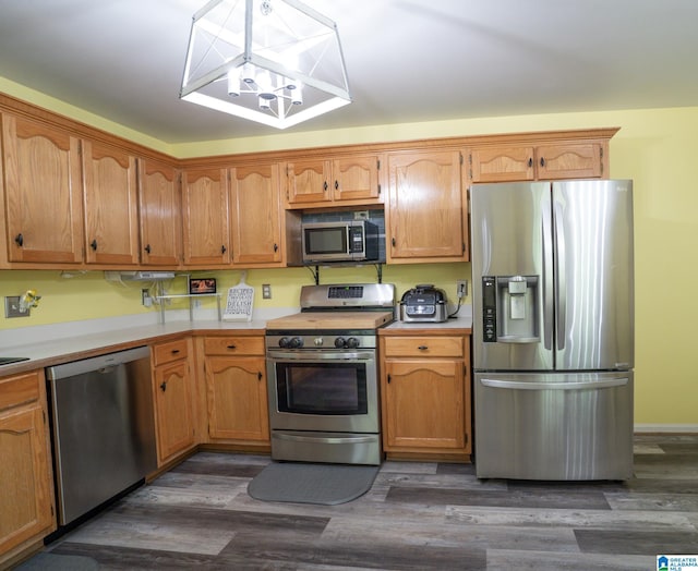 13339 Sylvia Dr, Lake View, AL 35111 - kitchen with appliances with stainless steel finishes, light countertops, dark wood finished floors, and brown cabinetry