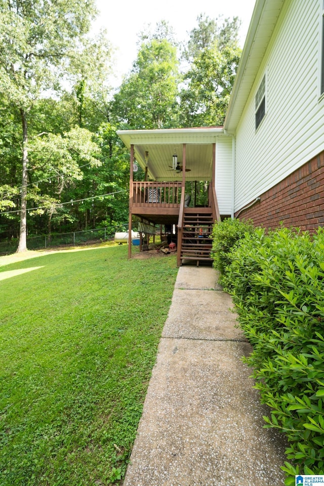 13339 Sylvia Dr, Lake View, AL 35111 - view of green lawn featuring stairs, a deck, and view of wooded area