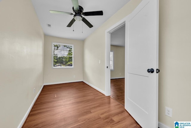 741 Center Pl SW, Birmingham, AL 35211 - empty room featuring healthy amount of natural light, light wood-style floors, and a ceiling fan