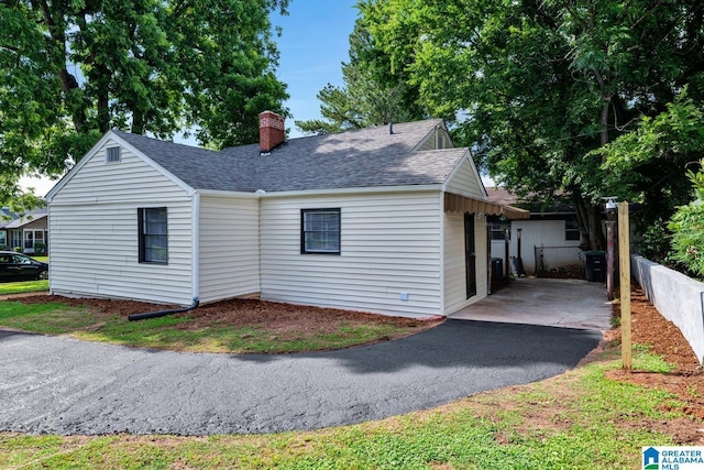 741 Center Pl SW, Birmingham, AL 35211 - view of front facade with a shingled roof, a chimney, and asphalt driveway