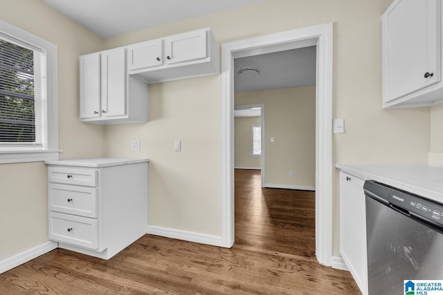 741 Center Pl SW, Birmingham, AL 35211 - kitchen with dishwasher, wood finished floors, light countertops, white cabinetry, and plenty of natural light
