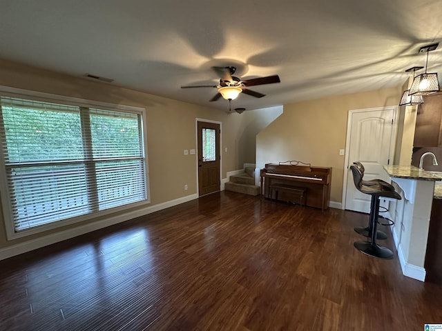 21131 Delmar Dr, Lake View, AL 35111 - living room featuring a ceiling fan, stairs, and dark wood-style flooring