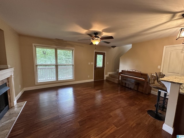 21131 Delmar Dr, Lake View, AL 35111 - unfurnished living room with a fireplace, a ceiling fan, dark wood finished floors, and stairway